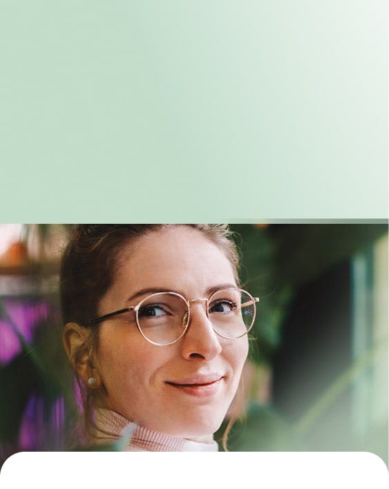 Woman sitting beside a plant